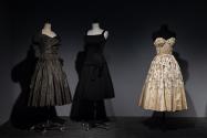 Dior + Balenciaga, Left to right: 82.208.9 (grey dress), 71.213.25 (black dress), 75.86.5 (strapless evening dress)