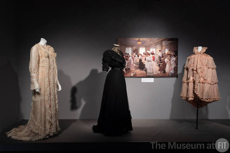 Designing Women_03 Left to right: Fernande Burel, Tea Gown, Paris, circa 1900 (2003.12.1); Jeanne Paquin, Afternoon dress, Paris, circa 1902 (72.66.6); Image by Henri Gervex, "Cinq Heures Chez Paquin" (Five Hours at the House of Paquin), 1906; Jeanne Paquin, Evening Cape, Paris, 1897 (P83.19.7)