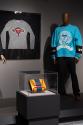 Section on “Politics” featuring, from left to right, Gabriela Hearst’s Ram Ovaries sweater (2021.48.1), Yliana Yepez’s Mini Giovanna bag in the colors of the Venezuelan flag (2022.78.1) and “No Human is Illegal” sweatshirt by Willy Chavarria x K-Swiss (2022.56.1).