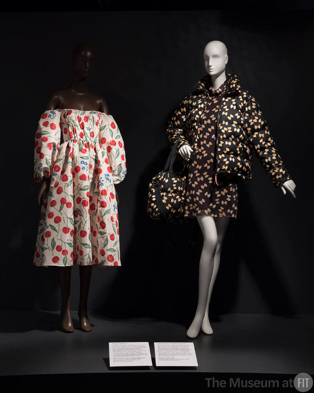 Wes Gordon for Carolina Herrera, cherry print dress, resort 2023. The Museum at FIT, Gift of Carolina Herrera; Rachel Antonoff, black pasta print ensemble, 2023. Lent by Rachel Antonoff