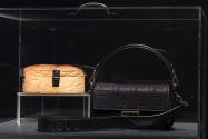 Food & Fashion Left to right: 87.37.1 (bread purse); Fendi, black Baguette bag, Fall/Winter 2023. Lent by Fendi S.r.l.