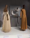 A portion of the Performance & Purpose section, featuring garments with detached sleeves. From left to right: evening gown by Balenciaga, c.1950 (84.1.5); sleeves by Undercover, spring 2005 (2023.33.1); jumpsuit by Rudi Gernreich, fall 1968 (97.39.1).
