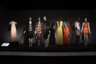 Fabric_17 Left to right P89.40.6 (dress), 80.13.19 (ensemble), 92.42.8 (multicolor  ensemble), 2003.16.3 (dress), 2015.77.1 (yellow gown), 2016.32.5 (top and pants), 2010.72.1 (knit dress), 2015.17.1 (dress)