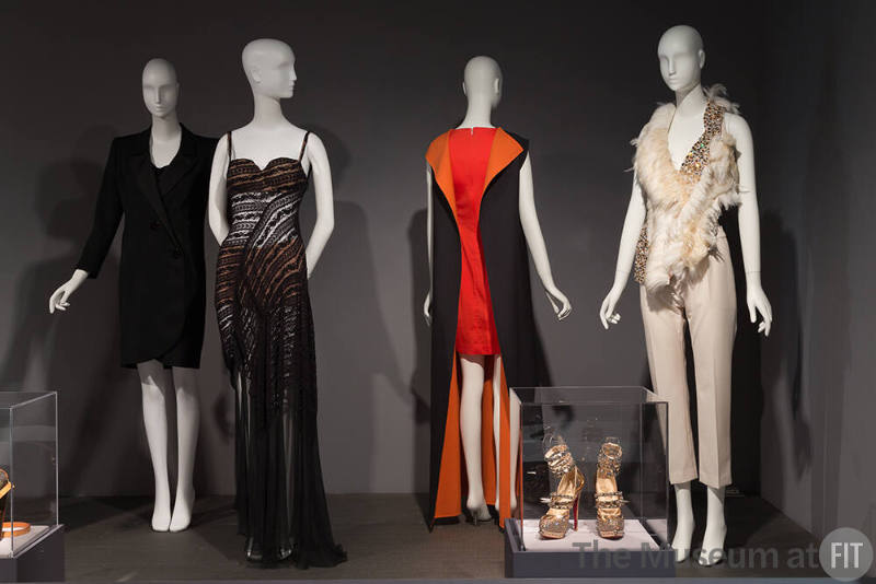 Global_19 95.85.9 (tuxedo dress), 2013.25.2 (dress), 2015.36.1 (orange dress),  2009.5.1 (shoes case), 2015.20.1 (white ensemble)