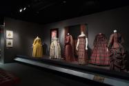 Trendology_11 Left to right P80.5.8 (coat), 87.120.1 (waistcoat), P88.14.6 (dress), 82.189.58 (textile wall), P85.19.1 (dress), P86.71.2 (shawl), 76.208.7 (man's dressing gown), 89.154.12 (dress), 68.175.1 (shawl wall), P88.9.1 (empire dress), 70.15.15 (full skirt dress), P88.22.1 (dress)