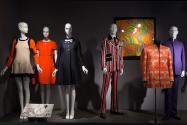 Trendology_33 Left to right 2012.27.1 (dress), 90.163.3 (orange dress), 85.151.5 (dress), 2001.55.1 (striped suit), 81.211.47 (textile wall), 2008.15.1 (jacket), 84.79.1 (suit) 