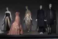 Fashion A-Z (II)_20 Left to right 75.124.3 (gown), 91.241.127 (pink dress), 2011.35.1 (floral ensemble), 84.171.1 (coat ensemble), 2009.30.1 (ensemble) 