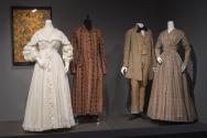 His and Hers_15 Left to right P85.41.7 (textile wall), P83.38.1 (gown), 76.208.7 (robe), P86.17.1 (suit), 2009.15.1 (dress)