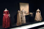 Arbiters_27 Left to right 2008.4.1 (dress), P92.2.13 (dress with fringe), P72.1.2 (dress with sash), 69.165.38 (shawl wall), 83.108.5 (cap case), P87.20.7 (floral dress)