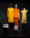 Exhibitionism_5 Left to right 77.21.4 (coat), 81.24.9 (orange pantsuit), 77.57.2 (dress)