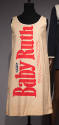 Beige knee length sleeveless dress with vertical Baby Ruth logo across front