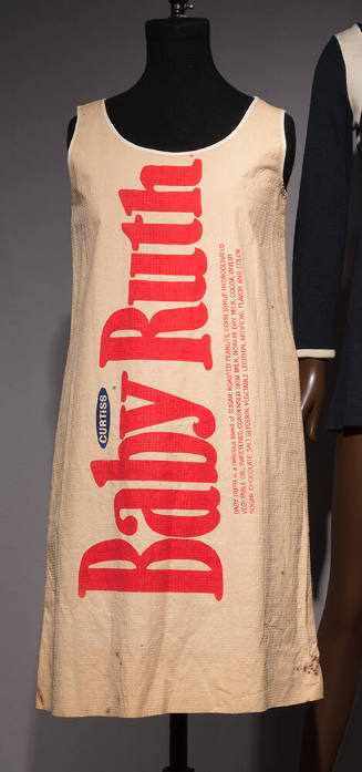 Beige knee length sleeveless dress with vertical Baby Ruth logo across front