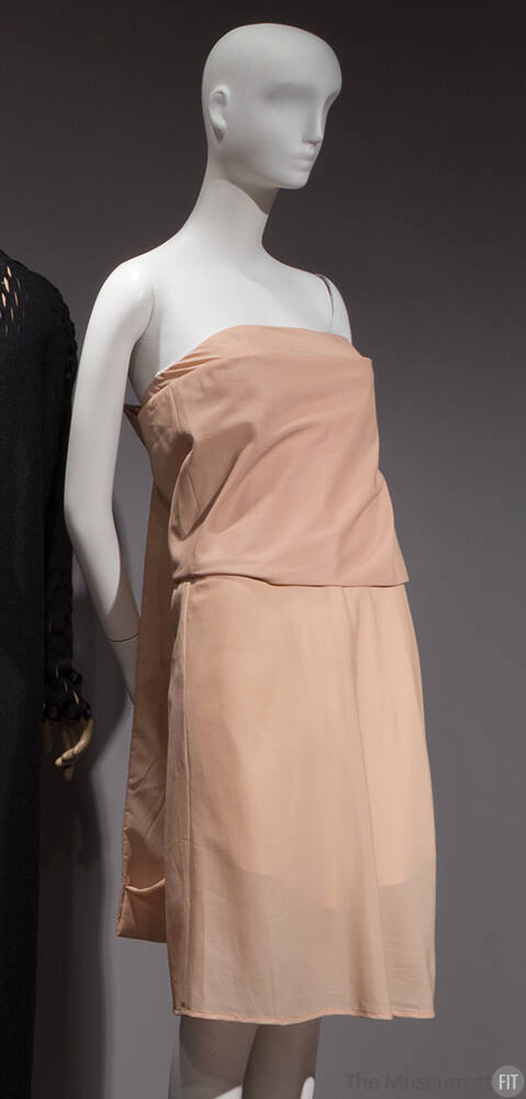 Beige strapless knee length dress with overlaying panel around bodice