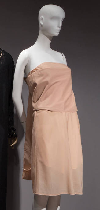 Beige strapless knee length dress with overlaying panel around bodice