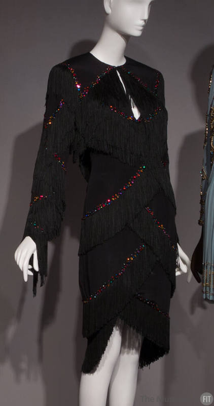 Black evening set: strapless short dress and bolero jacket with scalloped rows of rayon fringe …