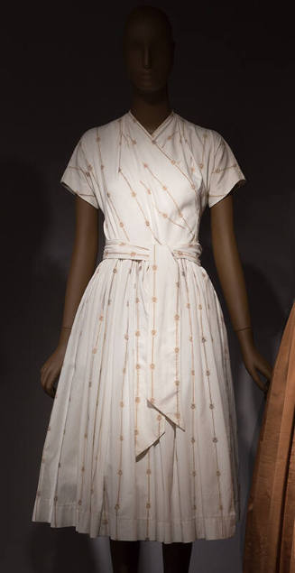 White ribbed popover short sleeve  dress with fine beige and brown stripes and small crest moti…