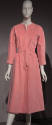 Pink Ultrasuede calf length wrap dress with V-neckline, long sleeves and large tie belt