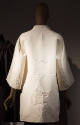 Back view of ivory jacquard coat with large pagoda motifs and wide kimono sleeves