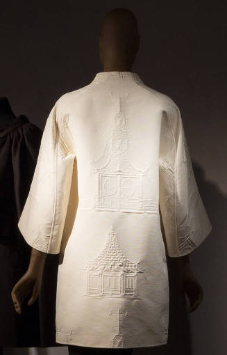 Back view of ivory jacquard coat with large pagoda motifs and wide kimono sleeves