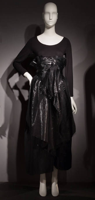 Black long sleeve body suit with black shiny high-waisted ankle-length wrap skirt 