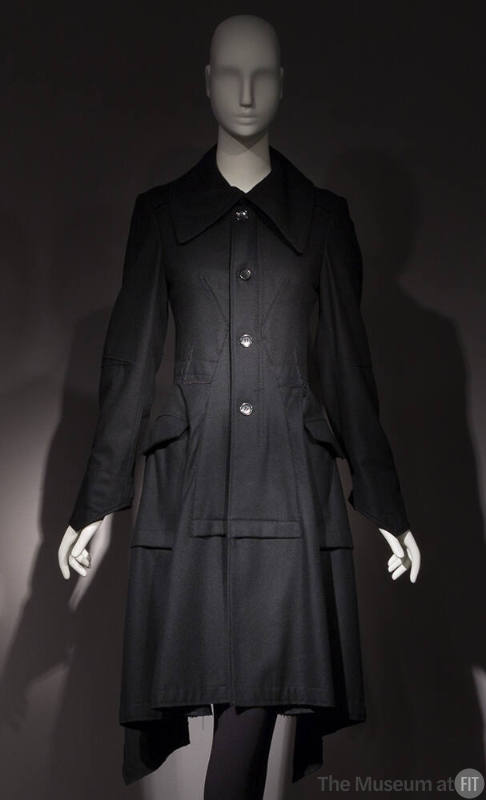 Black long sleeve four button front to-the-knee coat with large collar, patch hip pockets 