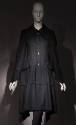 Black long sleeve four button front to-the-knee coat with large collar, patch hip pockets 