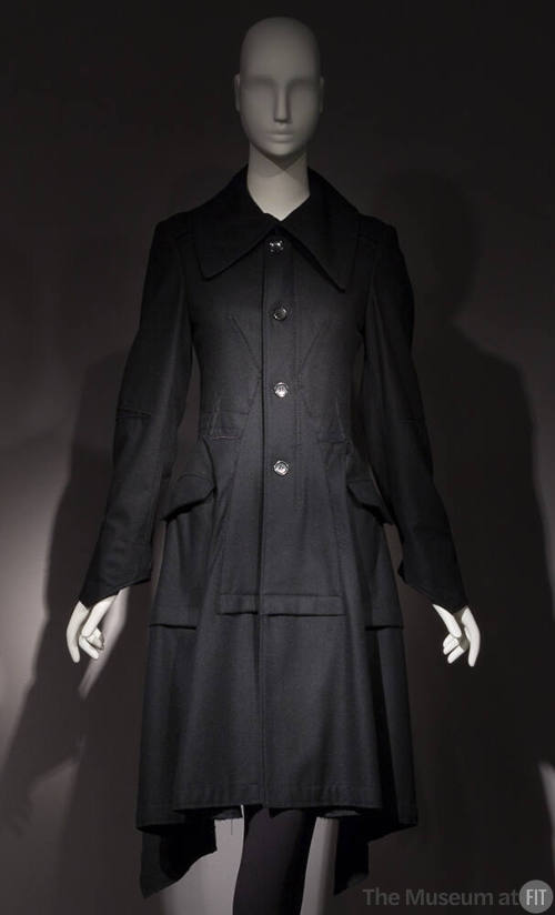 Black long sleeve four button front to-the-knee coat with large collar, patch hip pockets 
