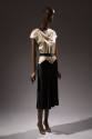 Dress with white cowl neck bodice cut to a pointed center front; attached black skirt 