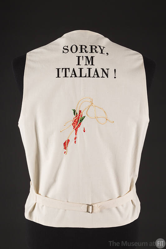 Back view of off-white vest with  text Sorry, I'm Italian! at upper back above embroidered spag…