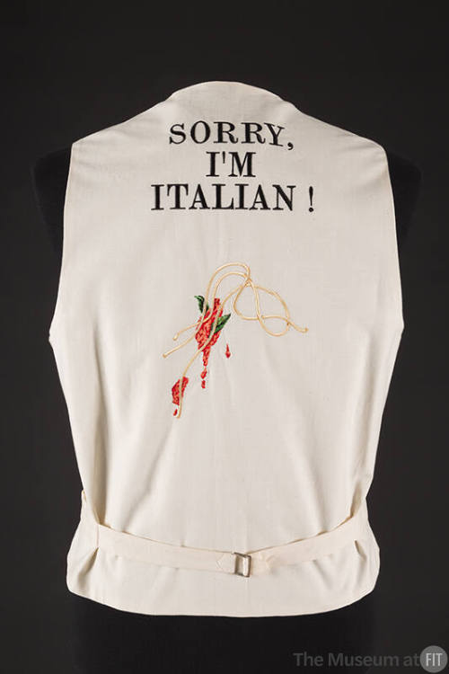 Back view of off-white vest with  text Sorry, I'm Italian! at upper back above embroidered spag…
