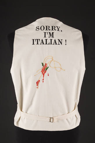 Back view of off-white vest with  text Sorry, I'm Italian! at upper back above embroidered spag…