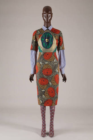 ¾ sleeve knee length shirt dress with orange stylized geometric motifs and blue, green and gold…