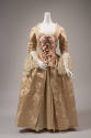 Pale pink silk floral damask dress with white lace sleeve panels, pink bows descending in size …