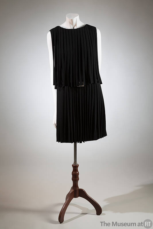 Black knee-length evening dress with two tiers of fringe at neck and waist