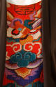 Detail of center neckline and bodice of red / multicolor Chinese cloud inspired print dress