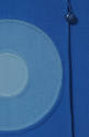 close up of medium blue and light blue inset circles on blue coat