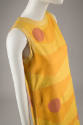 Sleeveless yellow knee-length dress with horizontal wavy orange sections and interspersed red c…