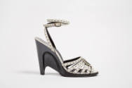 Side view of white leather sandal with sculpted black semi wedge high heel and ankle strap