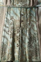 Detail view of bottom half of blue/green girdle showing gold metallic brocaded floral design, m…