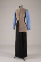 Beige linen tunic/jacket dressed over blue long sleeve shirt with left panel tucked into black …