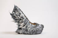 Single grey platform shoe covered in various growth-like protrusions
