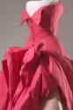 Detail back view of pink ballgown showing large sculpted panel extending from back to front and…