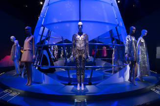 Expedition: Fashion from the Extreme exhibition installation view of dressed mannequins on a pl…