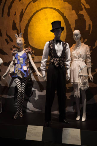 Fairy Tale Fashion exhibition installation view of dressed mannequins on a platform