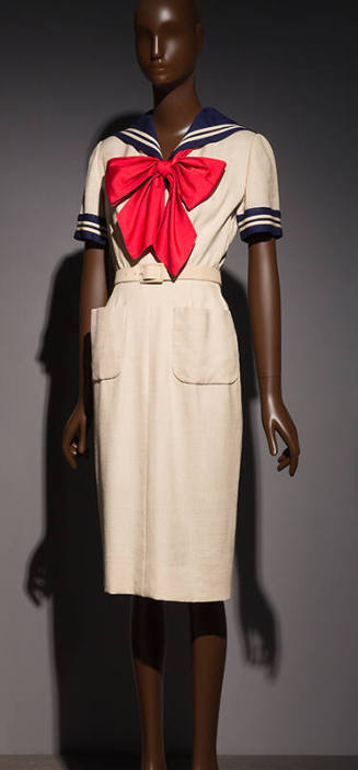 White sailor style knee length sheath dress with navy blue sailor collar, short sleeves, patch …