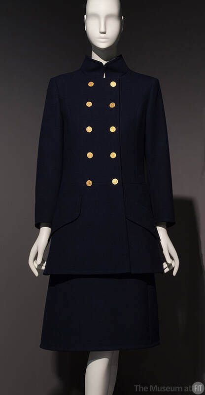 Navy blue military uniform style ensemble of coat with five pairs of gold buttons and knee leng…