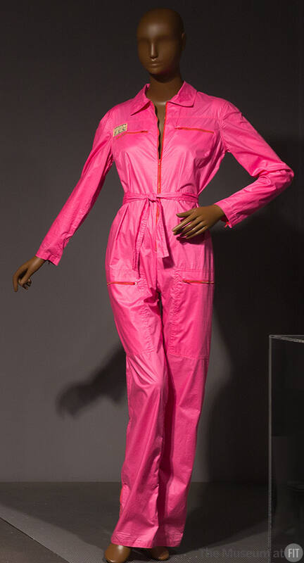 Hot pink long-sleeved flight suit or jumpsuit with exposed zippers, convertible collar