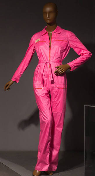 Hot pink long-sleeved flight suit or jumpsuit with exposed zippers, convertible collar
