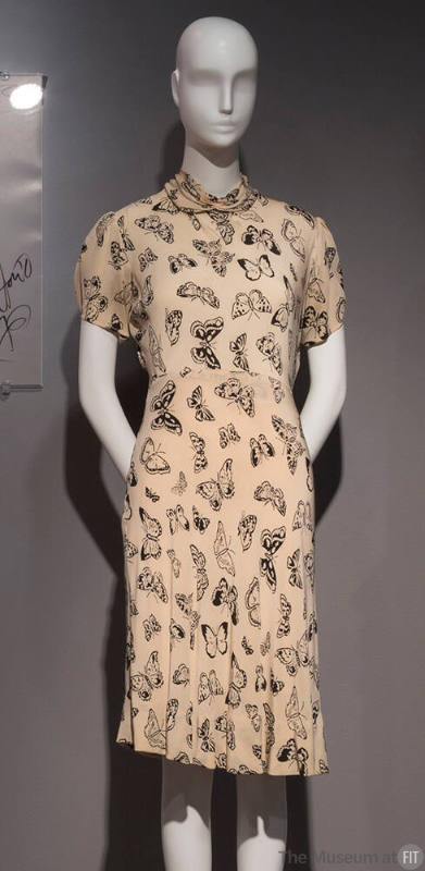 Ivory knee length dress with black butterfly print and turtleneck collar