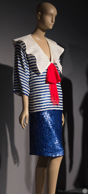 Sailor style blue and white horizontal sequin stripe top with large red bow and matching knee l…